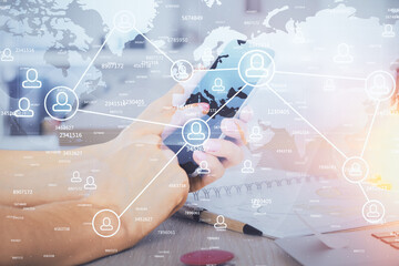 Double exposure of man's hands holding and using a phone and social network theme drawing.