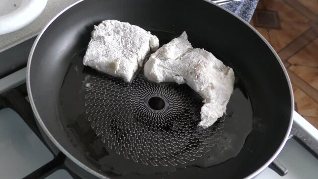 Home cooking process.  The cook is cleaning the cod fish.  Healthy food concept