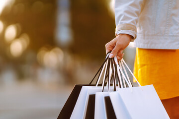 Shopping bags in the woman hands. Sale, shopping, tourism and happy people concept. 