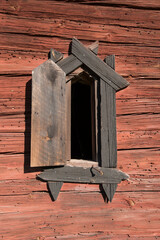 Ventilation windows in a old falu red wood barn from 1700s in the countryside of Stockholm