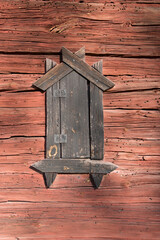Ventilation windows in a old falu red wood barn from 1700s in the countryside of Stockholm