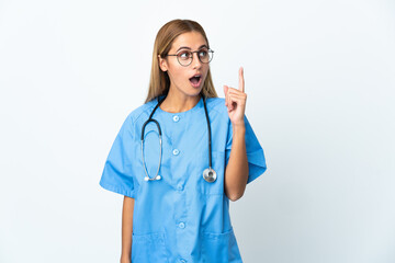 Surgeon doctor woman over isolated white background thinking an idea pointing the finger up