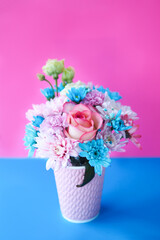 postcard beautiful bouquet of roses and chrysanthemums on a pink-blue background. copy space.