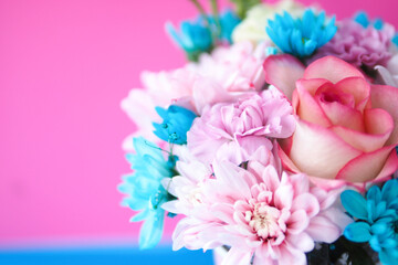 postcard beautiful bouquet of roses and chrysanthemums on a pink-blue background. copy space.