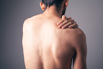 a young guy has a shoulder ache