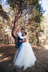 Fototapeta premium bride and groom walking in the woods
