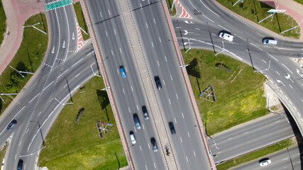 Flight over a multi-level road junction. Public transport is visible. City aerial photography.