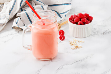 raspberry smoothie in glass jar for breakfast with copy space