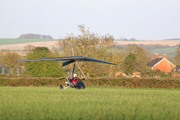 Ultralight airplane taxiing on a grass strip	