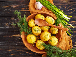 young boiled potatoes, dill background, garlic