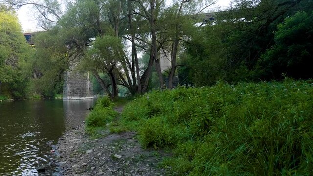 Bridge along a river with trees in Elora Ontario Canada