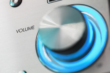 Shiny metallic volume control knob with text