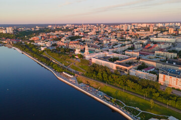 Aerial view of Perm and historical building, Kama river with bridge in sunny summer day with green trees in the sunset