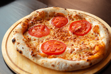 Pizza Margherita on wooden board close up