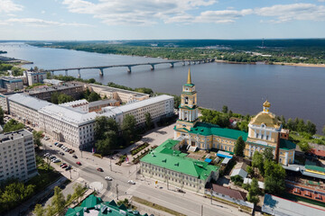 Fototapeta premium Aerial view of Perm and historical building of art gallery, Kama river with bridge in sunny summer day with green trees