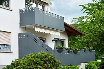 Balkon mit-Metall-Geländer und Kunststoff-Plattenverkleidung an moderner...