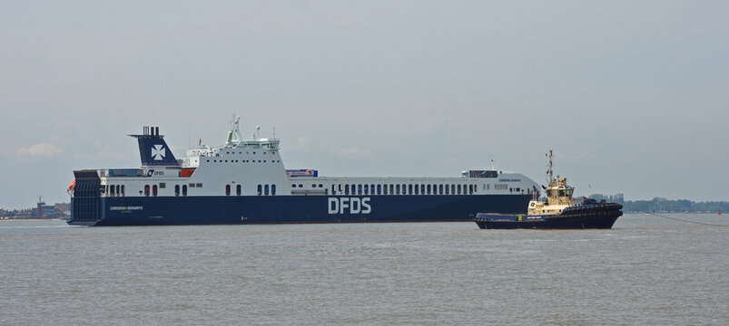 DFDS  Gardenia Seaways Ferry approaching Harwich Dock with tug boat in forground.