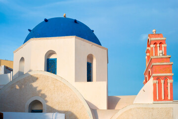 Famous view from viewpoint of Santorini Oia village with blue dome of greek orthodox Christian...