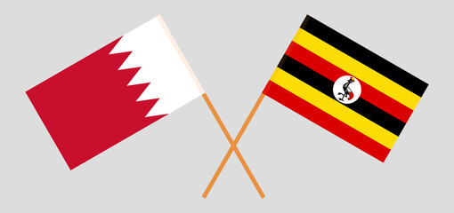 Crossed flags of Bahrain and Uganda. Official colors. Correct proportion