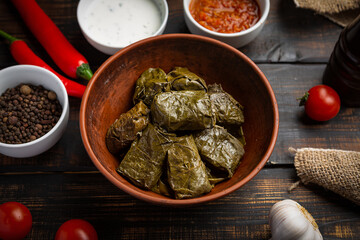 Dolma on a wooden rustic background. Traditional Caucasian, Turkish and Greek cuisine