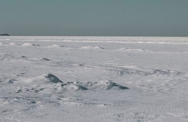 Sunny Winter Landscape. Snowy Sunny Field and Light Blue Sky. Snow-Covered Beach. Simple Minimalist Landcape ideal for Wall Art, Poster, Room Decoration. No People.