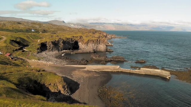 Arnarstapi coastline in sumemr season, Snaefellsnes peninsula, Iceland. Aerial view from drone. Slow motion