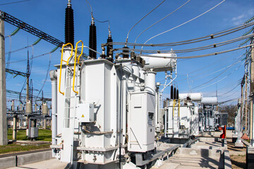 a powerful transformer substation with many connected high-voltage wires and cables, Transformers...