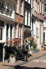 Amsterdam Jordaan Street View with House Facades and Walking Man