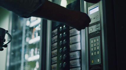 Close up of person choosing food from vending machine - obrazy, fototapety, plakaty