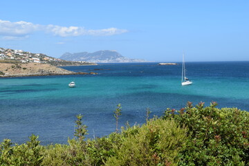 Relaxing on a yacht in the ocean, turquoise water with boats, blue sky and horizon with sailboats,...