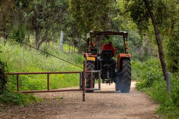 Tracktor on a trail with a gate.