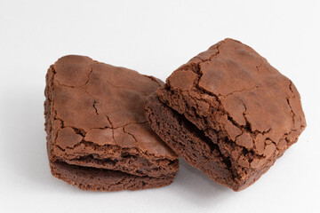 Brownies of chocolate on white background.