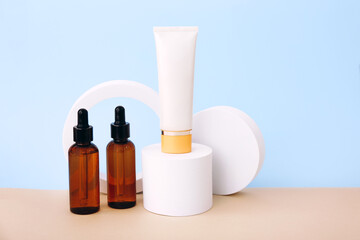 Cosmetic bottles on the geometric podiums. Presentation template for natural beauty products on beige background