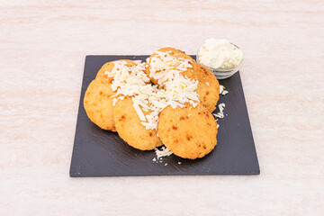 recipe for arepitas with cheese ideal for breakfast on a square plate