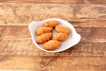 Serving of Iberian ham croquettes served in a Spanish tapas bar