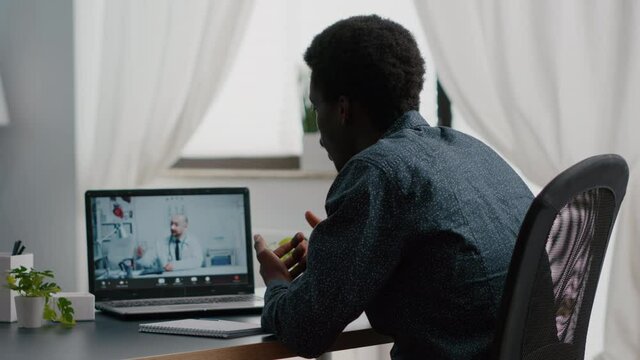 African american patient at home looking for medical help from doctor via online intenet telehealth consultation with family doctor. Health care checkup via video virtual conference, patient asking