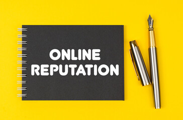 On a yellow background lies a pen and a black notebook with the inscription - Online Reputation