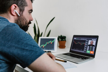 Young hispanic man learning to trade the stock market online. Investment and financial concept