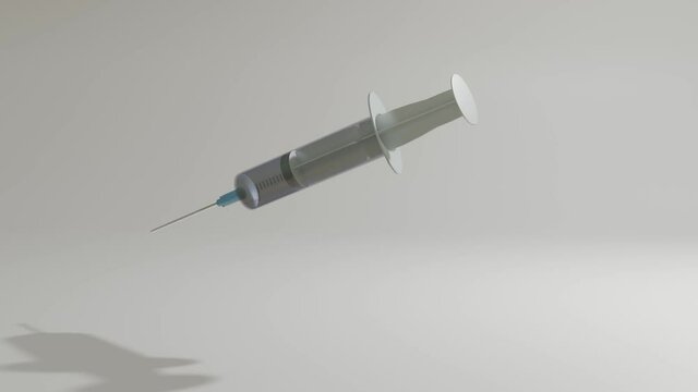 a three-dimensional model of a disposable syringe rotates slowly on a gray background. looped moving background. 3d render