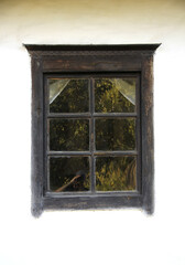 Old window on a wooden wall. Architecture.