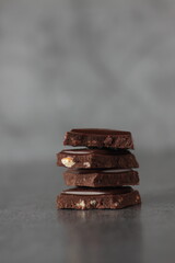 a pile of chocolate pieces isolated on gray background