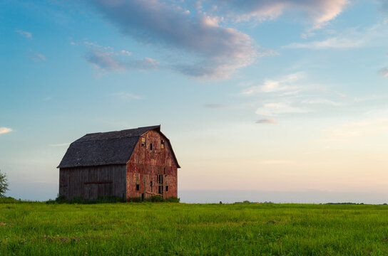 Old red barn at sunset.
