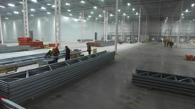 Aerial View Of Workers Inside Large New Modern Industrial Warehouse