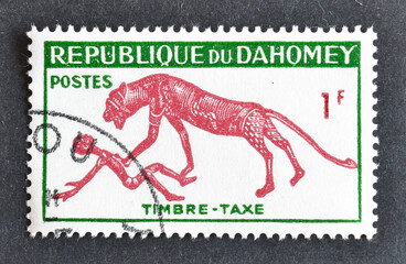 Cancelled postage stamp printed by Dahomey, that shows Panther over man, circa 1960.