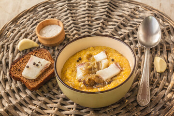 Banosh with toasted bacon and onions. Hutsul lunch.