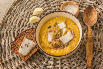 Banosh with toasted bacon and onions. Hutsul lunch. Flat lay