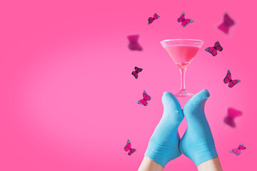 Blue socks with pink cocktail on a pink background