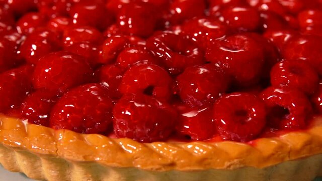 Close-up panorama of the delicious Fresh raspberry pie covered with jelly