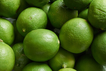 Green limes or lemons in the market background