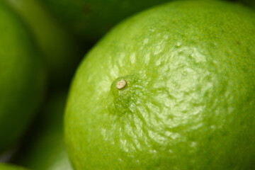 Green lemon on the background, close up of a lime